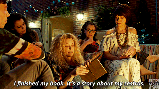 Helena explains her book to the other clones.