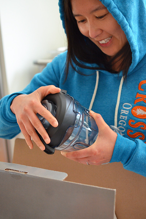 Someone unboxing a Vitamix.