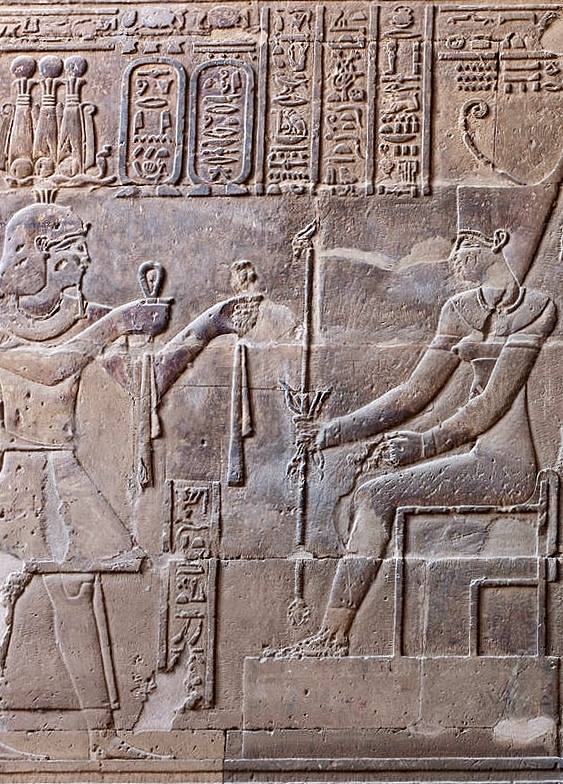 Temple of Neith and Khnum at ‘Iunyt’ (Esna), detail from the south-east wall of the Hypostyle Hall (second register): the King, the Emperor Septimius Severus (wearing the Triple 'Atef’ Crown with the two feathers) offering clothes to the Goddess...