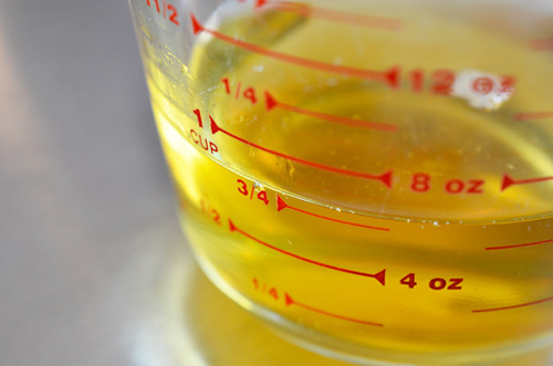 Apple juice measured out in a glass measuring cup.