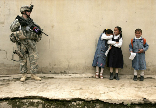 sixpenceee:
“16 April, 2007. A girl becomes embarrassed after giving flowers to a female US soldier on duty in the northern Iraqi city of Mosul.
”