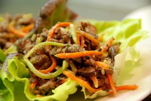 Paleo asian ground beef, mushroom, and broccoli slaw in lettuce cups.