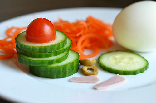 Sliced and spiralized vegetables on a plate for crazy clown eggs.