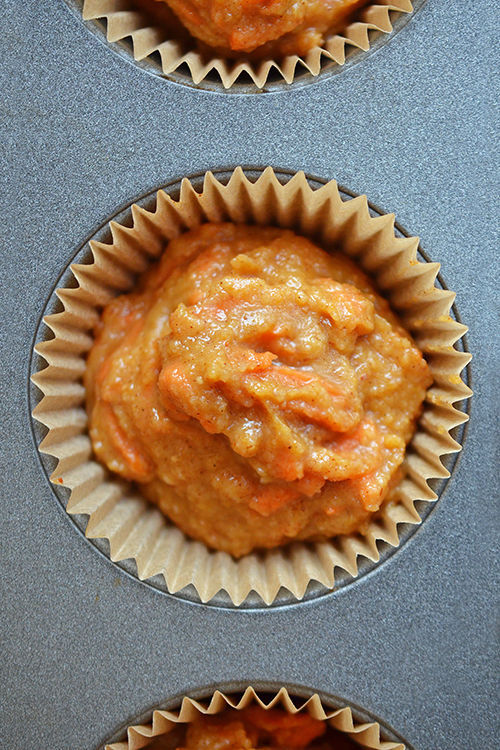 An overhead shot of Paleo Pumpkin and Carrot batter in a muffin tin.