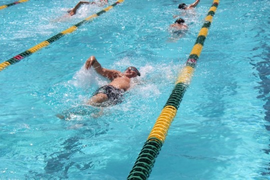 Sophomore Josh Hoye swims a backstroke set in Lane 7 during practice. Swim Team is now considered off season, meaning practice is only on Tuesdays and Thursdays.