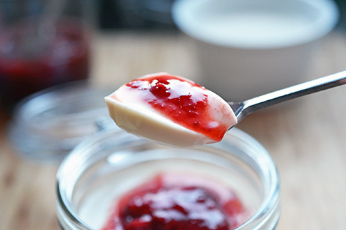 A spoonful of paleo panna cotta with strawberry balsamic compote.