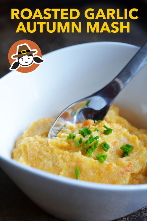 A bowl of roasted garlic autumn mash with a spoon.