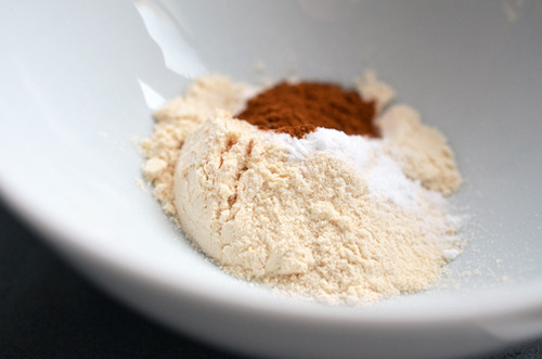 The dry ingredients for cinnamon and coconut paleo pancakes in a bowl ready to be whisked.
