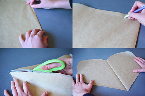 Cutting out heart-shaped pieces of parchment paper.