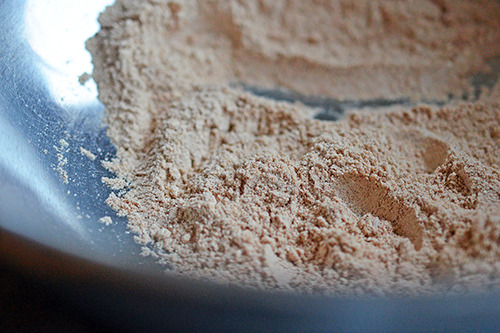 The dry ingredients for the paleo pancakes are mixed in a bowl.
