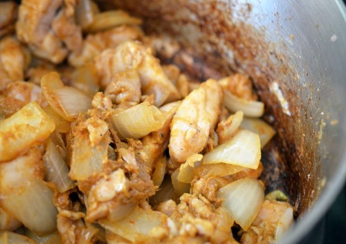 The contents of the pot are cooked until the spices for Thai Chicken Curry are dispersed.