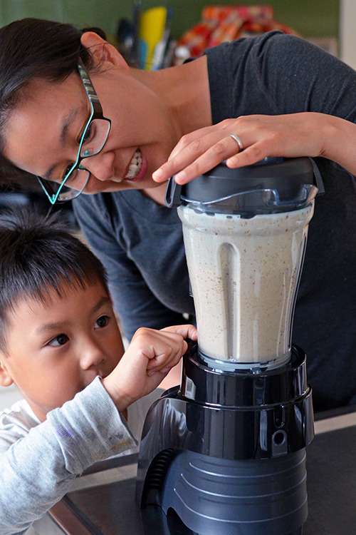 A mother and son are blending the ingredients to make paleo, Dairy-Free Vanilla Ice Cream 