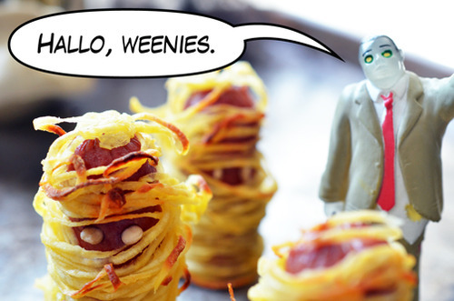 Two healthy Whole30 Yummy Mummies on a platter next to a plastic toy zombie.