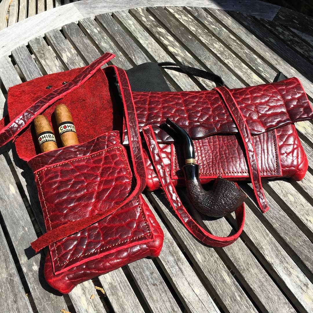 Thick, premium American bison leather. Two Oxblood leather cuts heading out to a customer - An #originaldesign cigar carrier and a 5 X 8 tobacco pipe pouch. Sewn with a durable bonded nylon thread. Shown with my personal pipe and my favorite cigar...