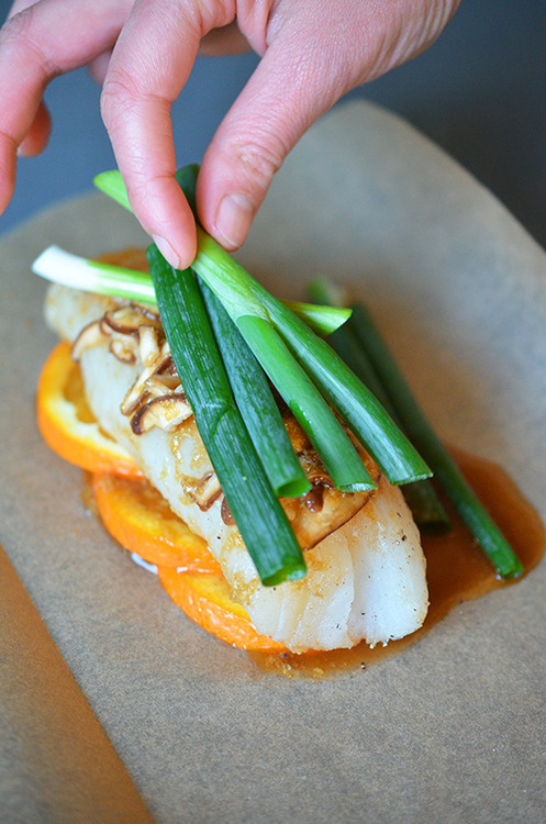 Green onion stalks are added to the Fish en Papillote (in Parchment) with Citrus, Ginger, & Shiitake 
