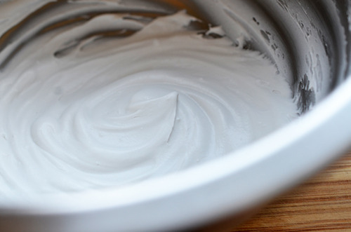 Whipped coconut cream in a mixing bowl.