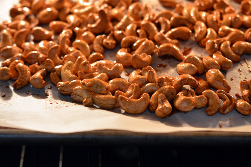 Honey vanilla cashews on a tray, baked in the oven.
