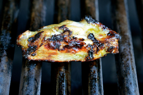 A chili lime chicken wing cooking on a grill.