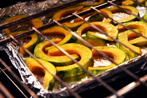 A tray of Roasted Kabocha Squash is baking in the oven.