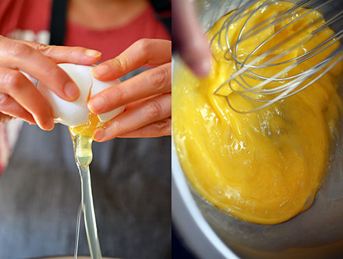 Cracking an egg and whisking it in a metal bowl.