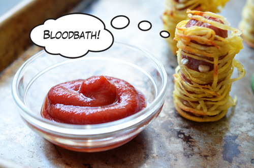 A paleo Yummy Mummy next to a bowl of ketchup with the word bubble that says bloodbath.