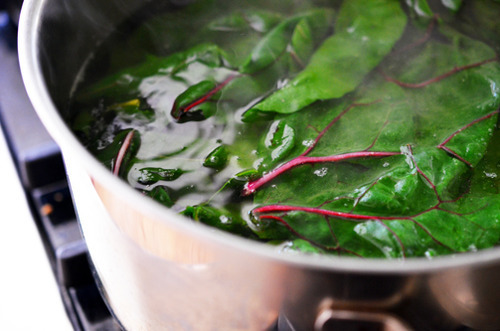 Boiling swiss chard in a pot.