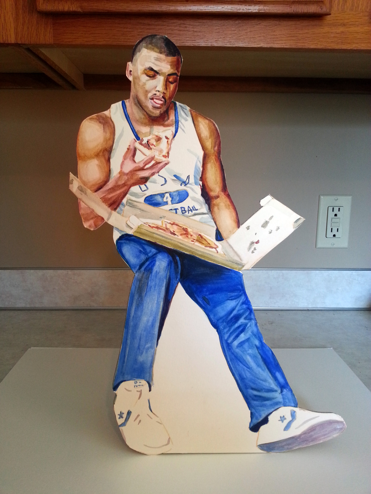 Hand-painted cardboard cutout of Charles Barkley eating a pizza.