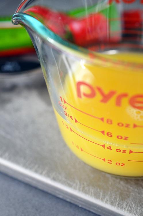 Closeup of orange in a Pyrex measuring cup.