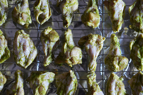 Chili lime chicken on a wire rack ready to be baked.