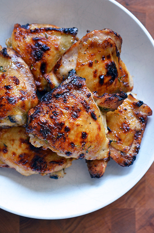 A plate piled with honey mustard chicken thighs.