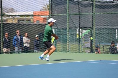  Sophomore Ethan Han hits the ball back to the opponent during his doubles match at the Varsity tennis game. Han later went on to help receive many of the hits to help his partner. 