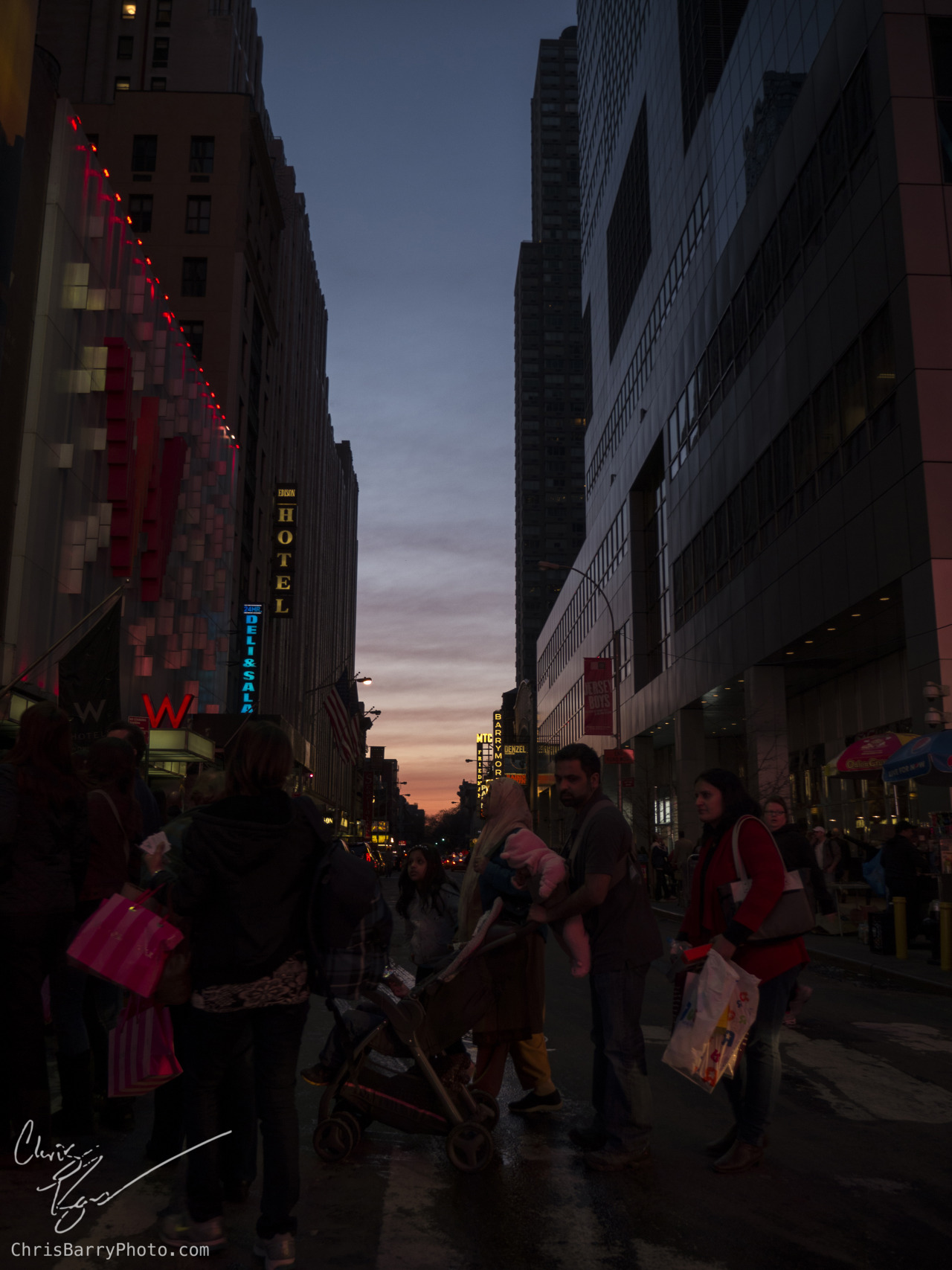 Sunset (probably somewhere around times square given the amount of people walking around)