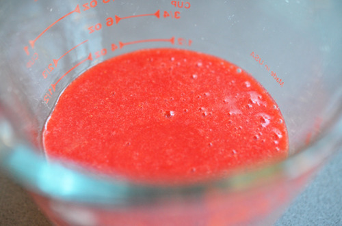 Puréed strawberries in a liquid measuring cup.