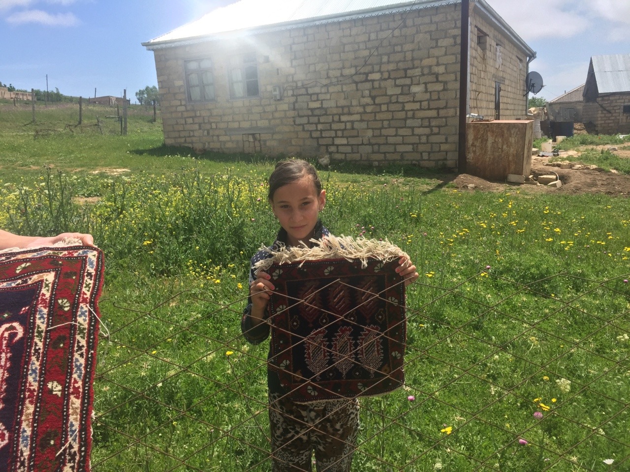 Above is the first carpet weaver that we met. She is thirteen years old and has been helping her mother weave since she was eight years old. She is holding up a piece that she made herself. Remarkably, this was the one family we met who did not use a...