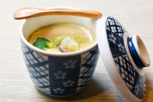 Paleo chawanmushi in a cup with a small wooden spoon on top.
