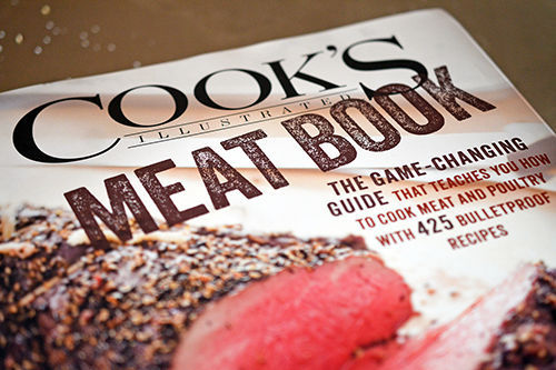 A shot of the cover of Cook's Illustrated Meat Book cookbook.
