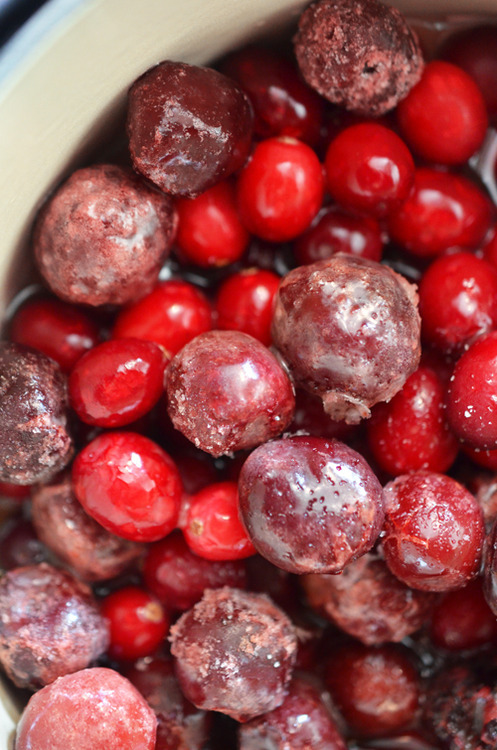 Cherries and cranberries piled in a pot.