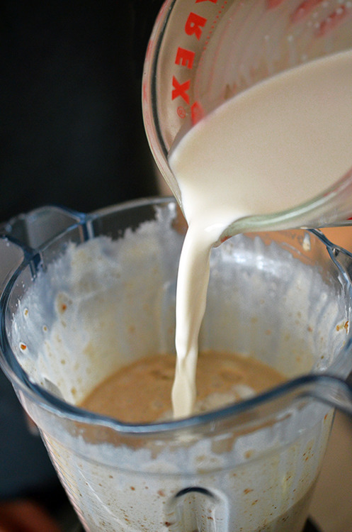Pouring almond milk into a blender to make Dairy-Free Vanilla Ice Cream 