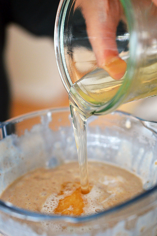 Pouring bloomed gelatin into the blender to make Dairy-Free Vanilla Ice Cream and Chocolate Ganache 