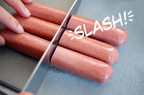 Cutting organic hotdogs with a knife to make Whole30 and paleo Yummy Mummies 