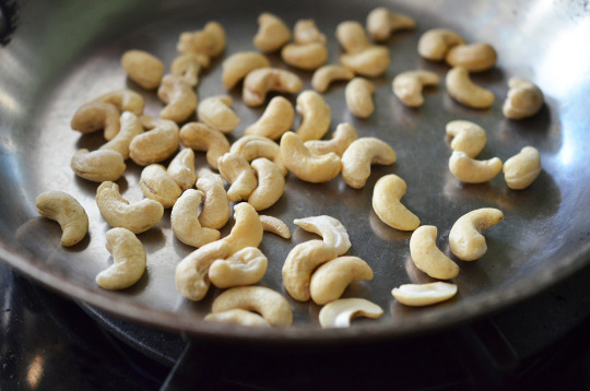 Toasting cashews on a pan.