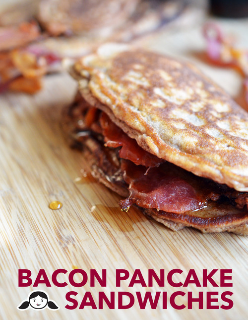 Bacon Pancake Sandwiches on a wooden cutting board.