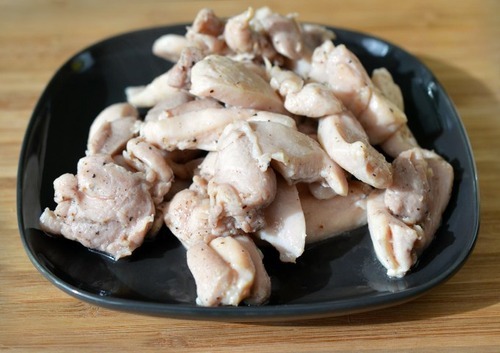 The cooked chicken thighs are transferred to a platter for Whole30 thai curry chicken