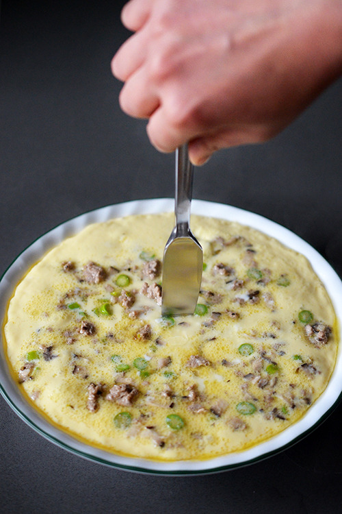 A butter knife is stuck inside the middle of the Cantonese Egg Custard with Minced Pork 