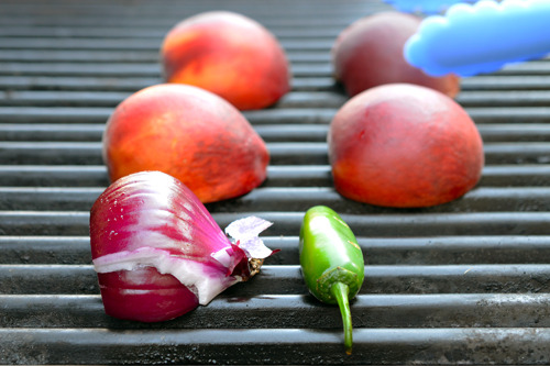 Grilling peach halves, jalapeno, and red onion to make a Whole30-Friendly spicy peach barbecue sauce that is both tasty and healthy.