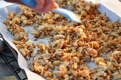 Stirring a tray of Tropical Paleo Granola during the baking time.