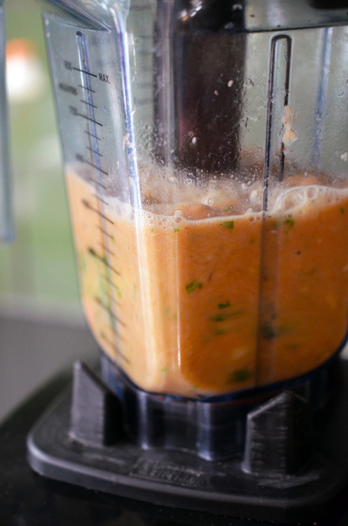 Puréeing the ingredients for Orange Sriracha Chicken in a blender.