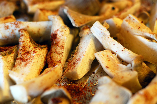 Chopped up king oyster mushrooms seasoned with Hawaiian fire seasoning salt.