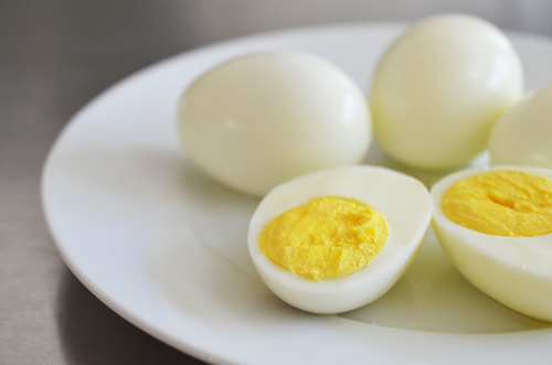 A hard boiled egg cut in half on a plate.