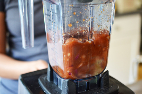 An action shot of the blending the Whole30-friendly marinade for the Peachy Pork-a-Bobs 